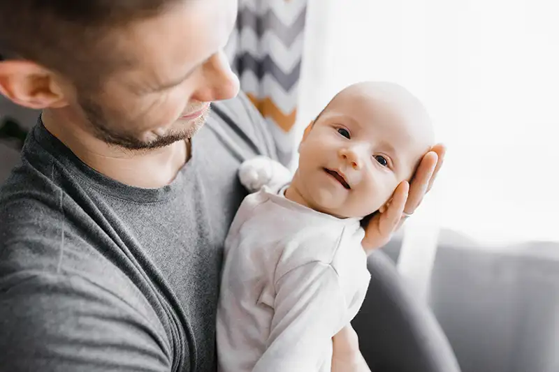 Happy-father-holding-baby-born-after-solving-male-infertility-issues